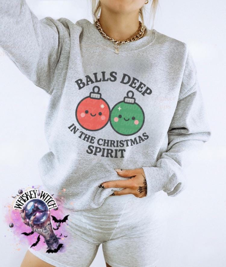 Close-up of cute Christmas ornament faces and rounded text on funny holiday sweatshirt