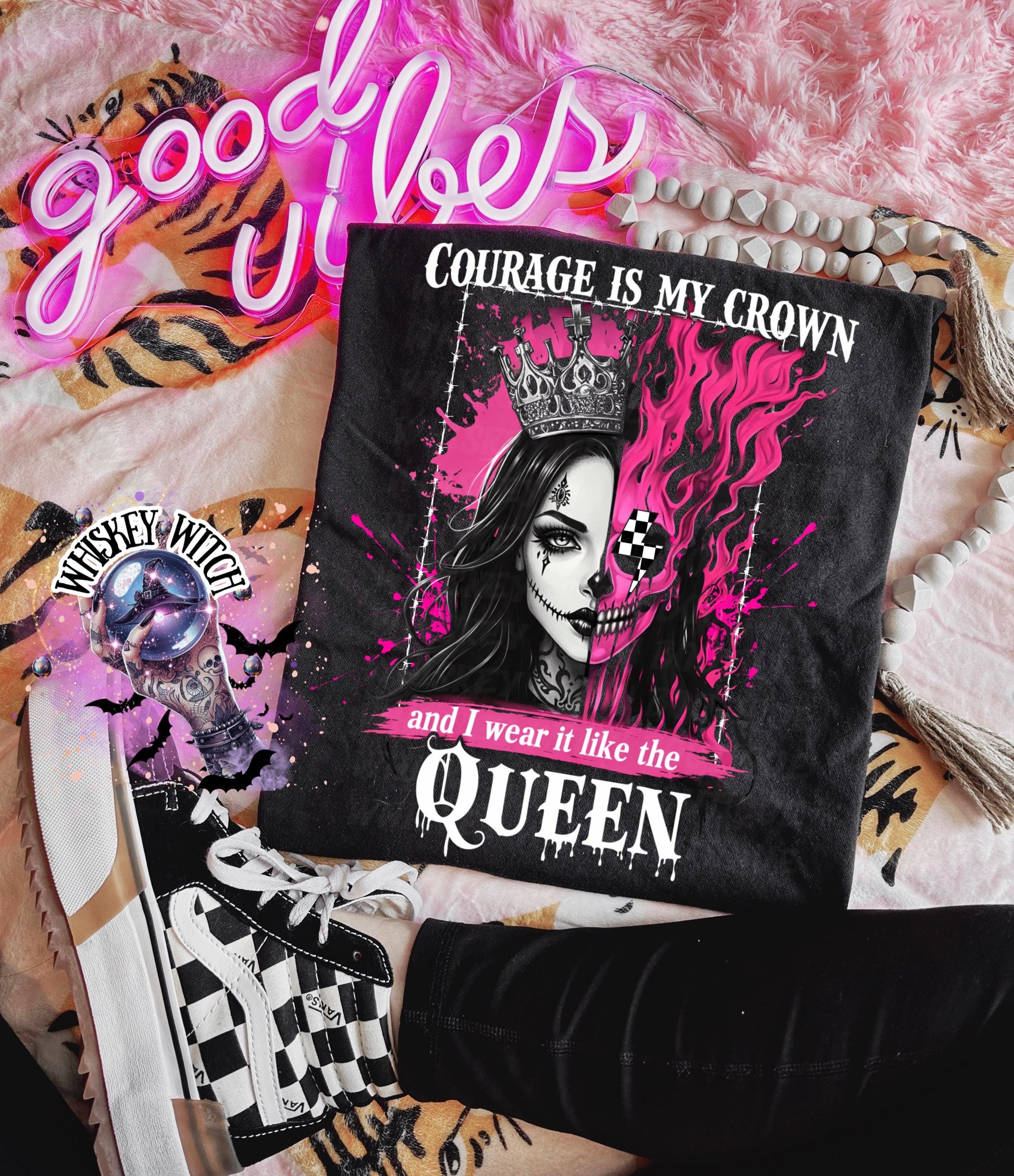 Lifestyle flat lay of gothic quote shirt styled with checkerboard shoes, bracelet, and pink aesthetic background for an edgy outfit vibe.