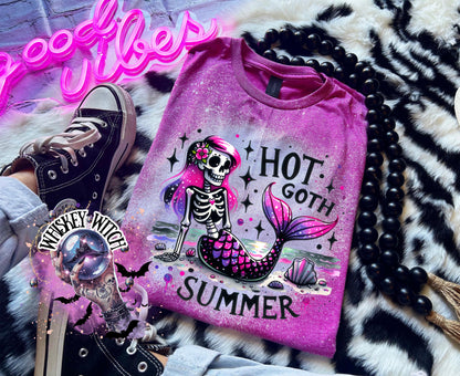 A Berry colored  t-shirt with a bleach-splattered design featuring a pink and purple skeleton mermaid with the text "Hot Goth Summer".