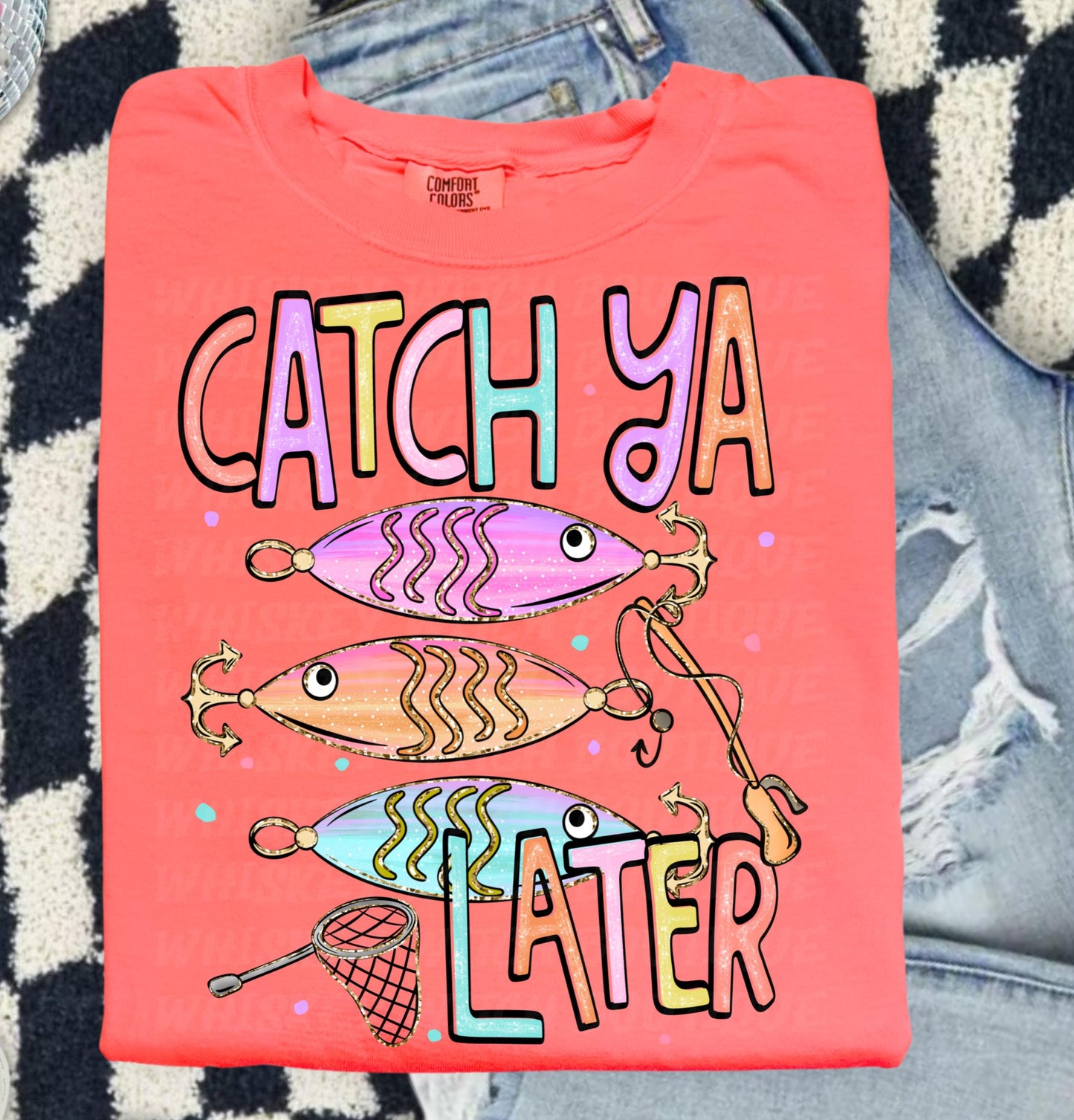 Cute lake day graphic tee with Catch Ya Later text, fishing lures, and a small fishing net design.
