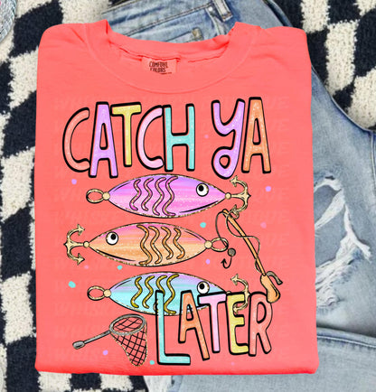 Cute lake day graphic tee with Catch Ya Later text, fishing lures, and a small fishing net design.