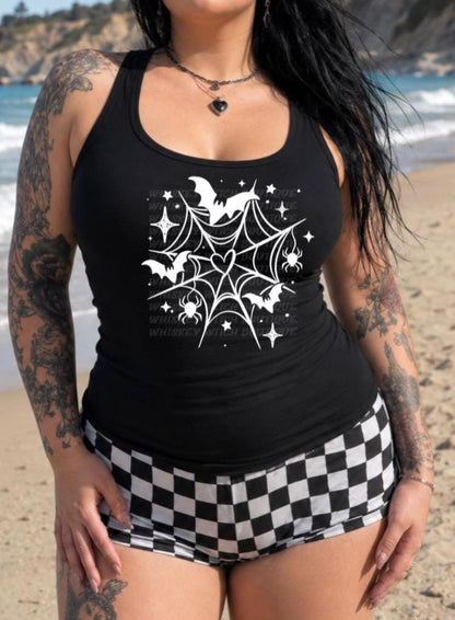 Close-up of white spiderweb and bat artwork on black tank top fabric